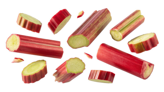 Fresh red rhubarb stalks chopped into pieces falling isolated on transparent background.