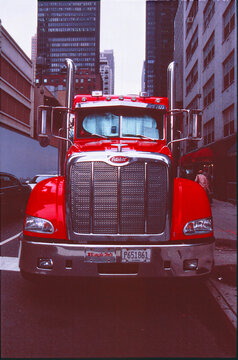 Front view of a red Peterbilt semi truck in Midtown Manhattan, New York City