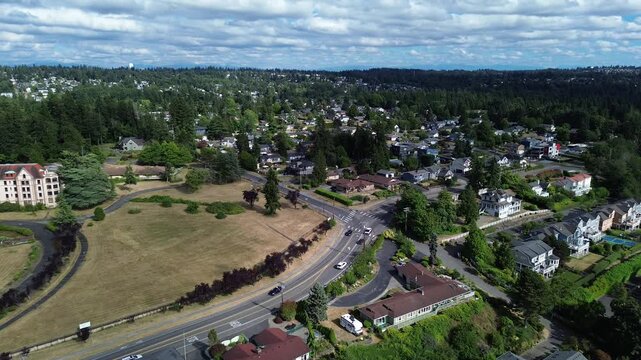 Historic campus structures sit near open fields arterial roadways, distinct community landmark, positioning connects formal institutional grounds with sprawling suburban backdrop, Des Moines, WA
