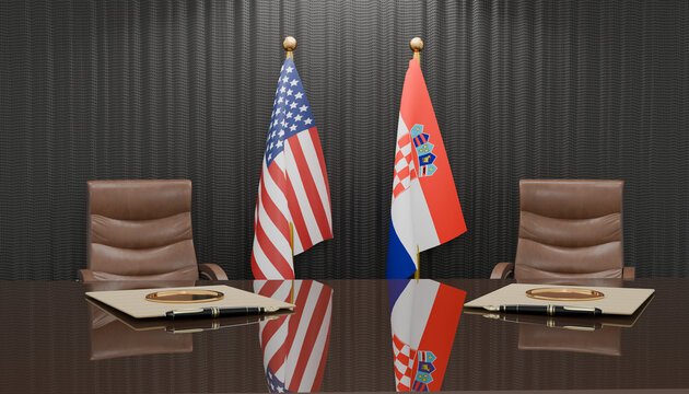 Diplomatic Meeting: Two national flags, the United States and Croatia, stand proudly behind a polished conference table, symbolizing international relations and partnership between the two countries.