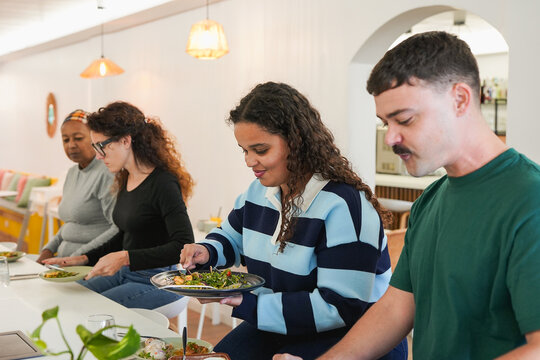 Multiracial people eating lunch inside modern restaurant - Healthy food, lifestyle and friendship concept