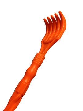 Orange back scratcher with curved tines plastic handle against a black background