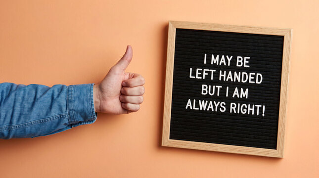 Left handed person giving thumbs up with motivational chalkboard sign