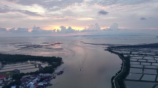 Aerial view of tranquil coastal waters at twilight. Vast waterway separates land at Sungai Udang, Penang