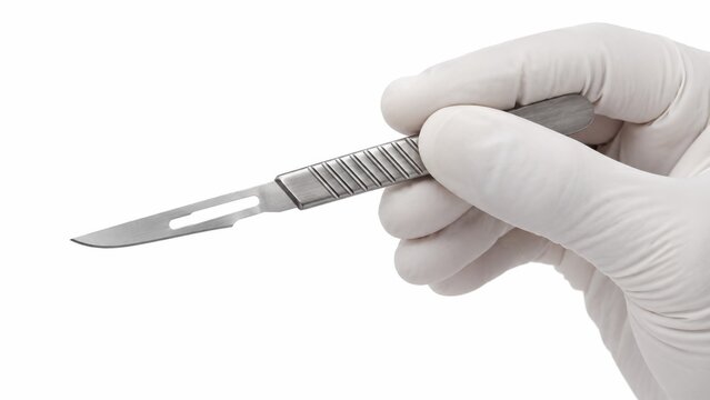 Gloved hand holding sterile surgical scalpel for dermaplaning
