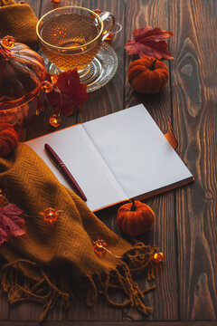 Cozy autumn desk composition with tea and notebook