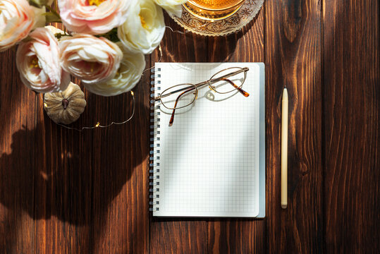 Creative workspace flat lay with notebook and glasses
