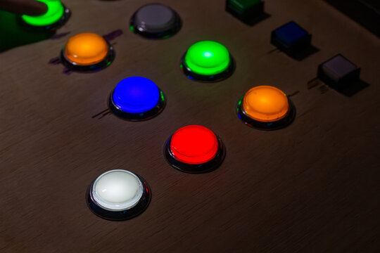 Colorful glowing buttons on a control panel for gaming or industrial equipment