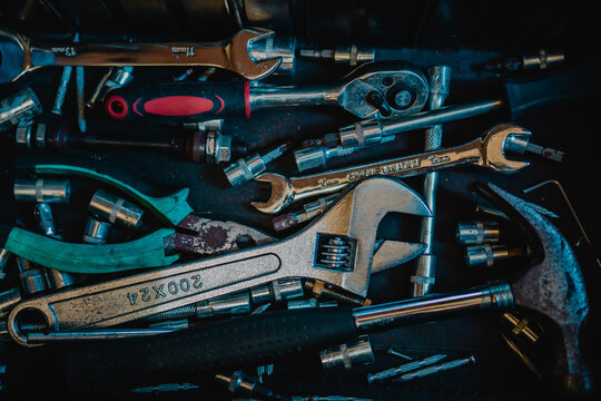 Assorted Hand Tools in a Dark Workshop Setting