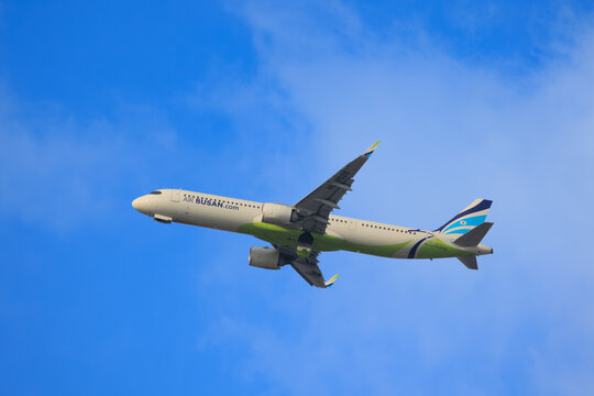 Air Busan Airbus A321 in side profile climbing against a blue sky on February 22, 2025 in Fukuoka, Japan.