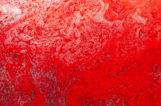 Bright red abstract texture fills the space with swirling patterns and shapes