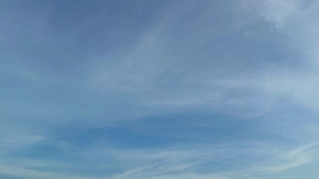 Beautiful blue sky background with moving soft white clouds time lapse video