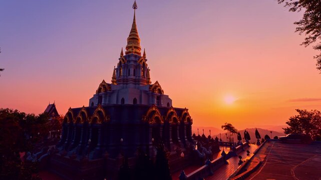 Time lapse Sunrise creates a magical atmosphere around the sacred pagoda at Wat Santikhiri Temple, where golden light, mountain landscapes, and Buddhist heritage combine into an unforgettable view.