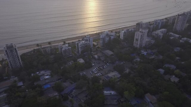 Aerial drone view of Versova Beach at sunset with Mumbai skyline India,
Golden hour aerial panorama of Versova Beach Mumbai Maharashtra

