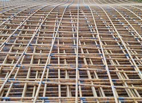 Rusty wire mesh reinforcement grid for concrete slab construction close-up background