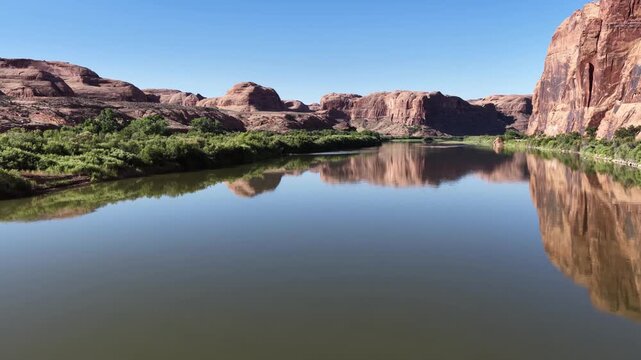 Drone footage close to the water of the Colorado River and close up of the cliffs along the Potash Road Turn near Moab, Utah