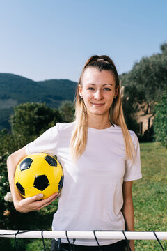 Young woman holding soccer ball