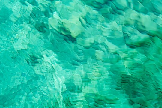 Rippled turquoise water surface. Ocean wave texture background