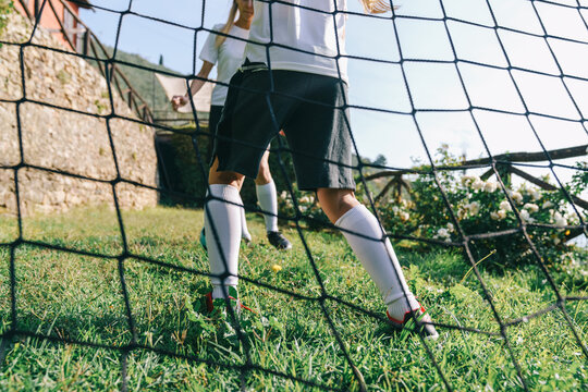 Two soccer players train on the sports field