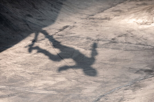 Skateboarder shadow on concrete
