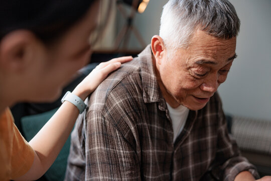 Comforting hand on shoulder of sad, older man.