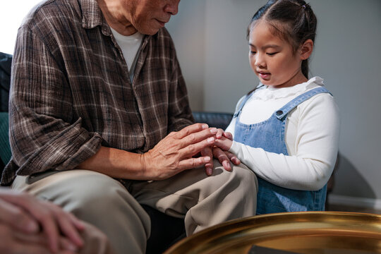 Grandfather and granddaughter share a tender moment of connection.