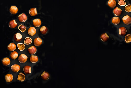 Hazelnuts on a black background. Top view. Copy space.