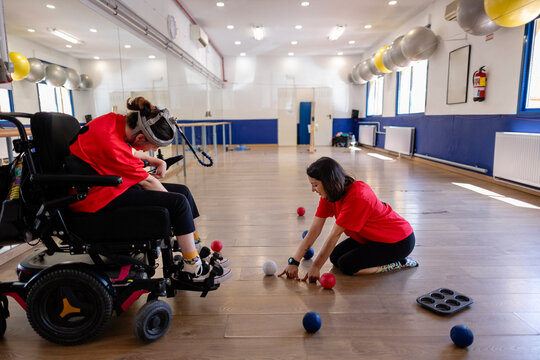 People playing inclusive boccia sport in activity room
