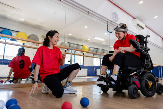 Women engaging in boccia game fostering inclusion
