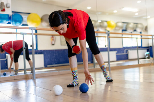Woman playing boccia concentrating on strategy