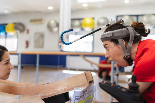 Woman with assistive technology working with therapist