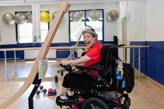 Woman with disability playing boccia with assistive device