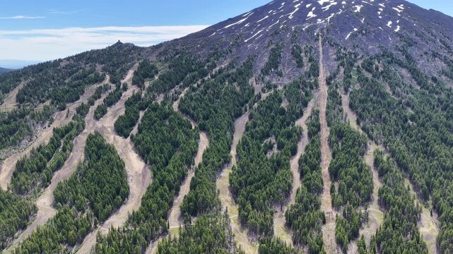 Mt. Bachelor and its many ski trails rise from the Deschutes National Forest in Oregon. This iconic volcanic mountain is part of the Cascade Range and just 22 miles from Bend.