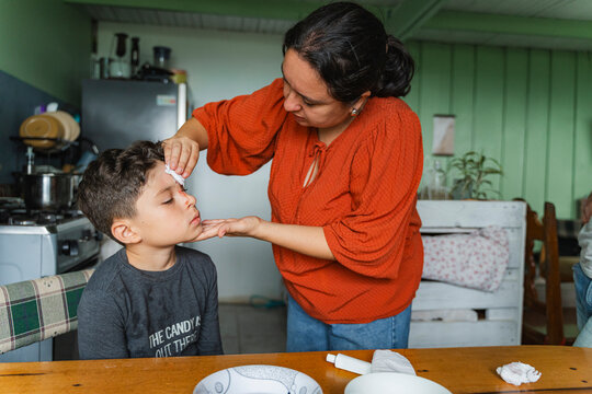 Mother providing first aid care for injured child