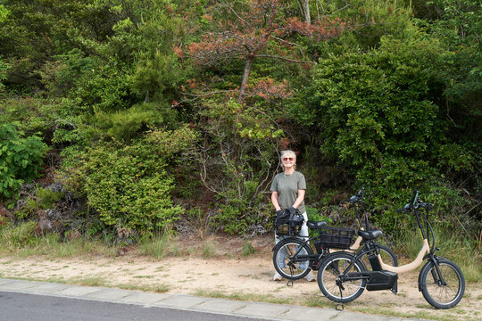 Tourists cycling around Naoshima Art Island using e-bikes
