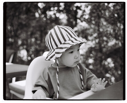 Toddler wearing striped sun hat