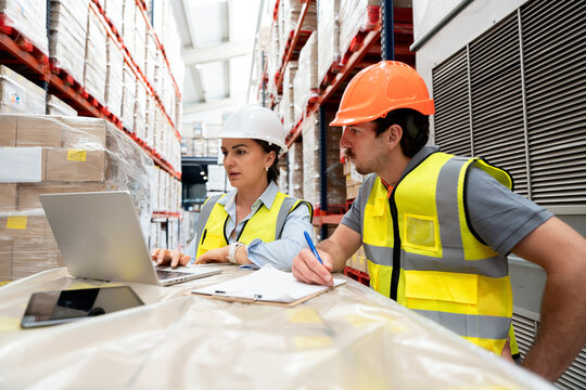 Warehouse workers managing inventory and logistics supply chain
