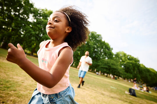 Cute girl runs towards in a park