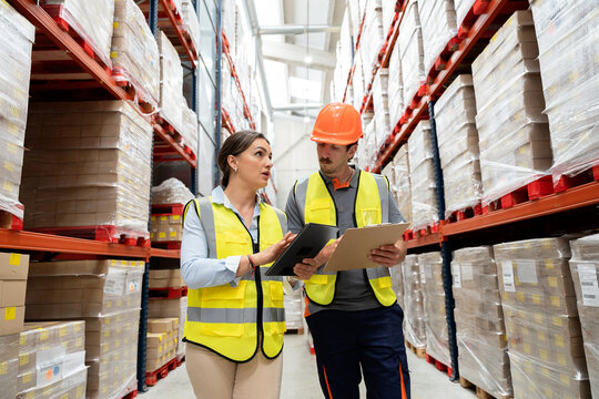 Logistic professionals planning inventory in warehouse