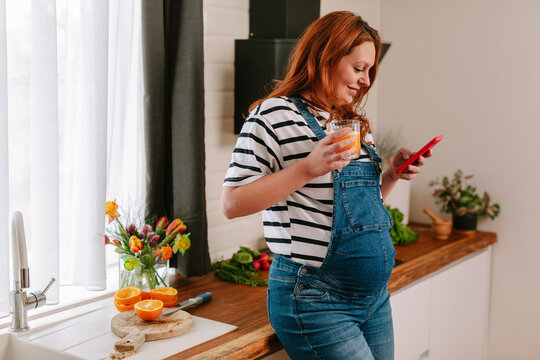 Pregnant woman drinking juice 