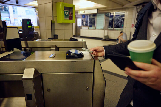 Man Uses Transit Card to Enter Subway Station