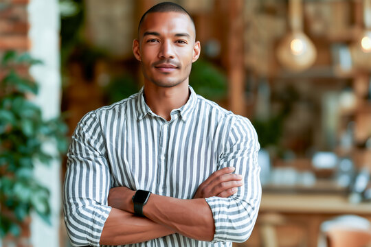 Young startup founder portrait, modern black or mixed race confident businessman posing at office with a casual shirt and a smartwatch