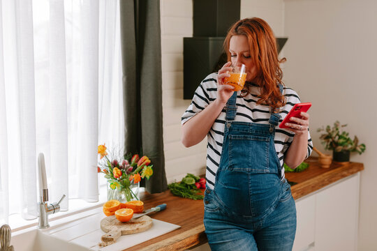 Pregnant woman drinking juice 