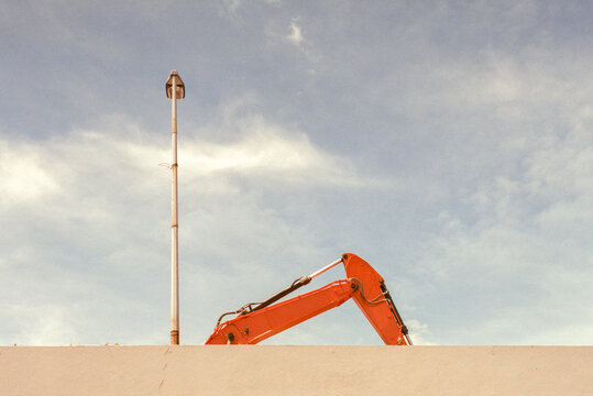 Excavator Behind Wall