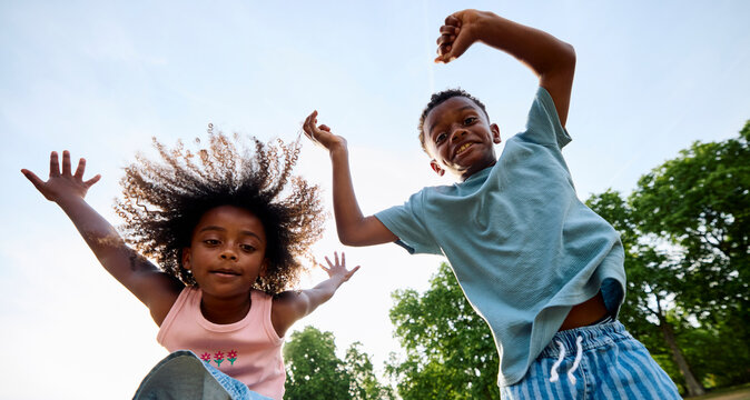 Kids Jumping With Joy in a Park