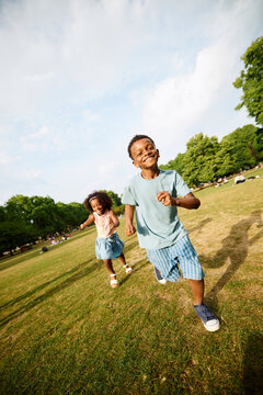 Children are playing tag in the park