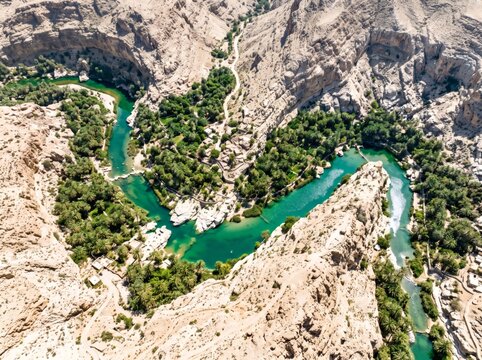 Turquoise River Canyon Aerial View with Emerald Pools, Rocky Landscape and Lush Green Oasis