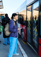 Nurse walking down the street  and using a mobile phone outside  waiting for transportation or ride or taxi or bus on station © Lumos sp
