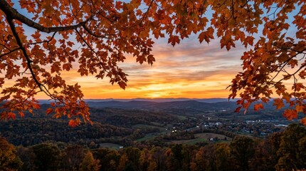 Fototapeta premium Autumn maple tree branches framing panoramic city skyline at sunset. Vibrant fall foliage over urban landscape with golden hour glow for scenic bac...