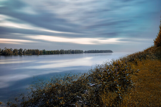 Sunrise over a calm river, nobody